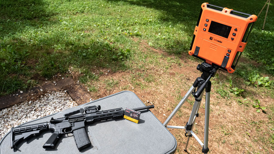 A rifle and a chronograph, used to measure muzzle velocity, at a shooting range